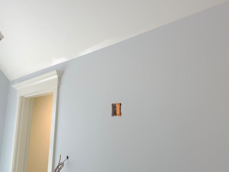 Clean paint line where a light blue wall meets a white sloped ceiling