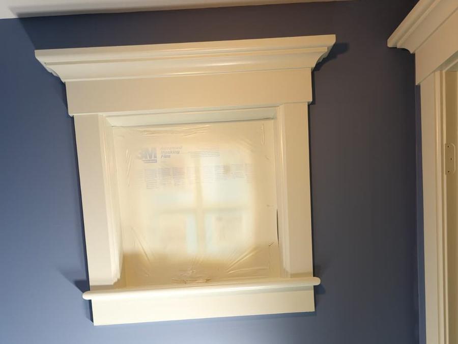 Deep navy accent wall with freshly painted white window trim