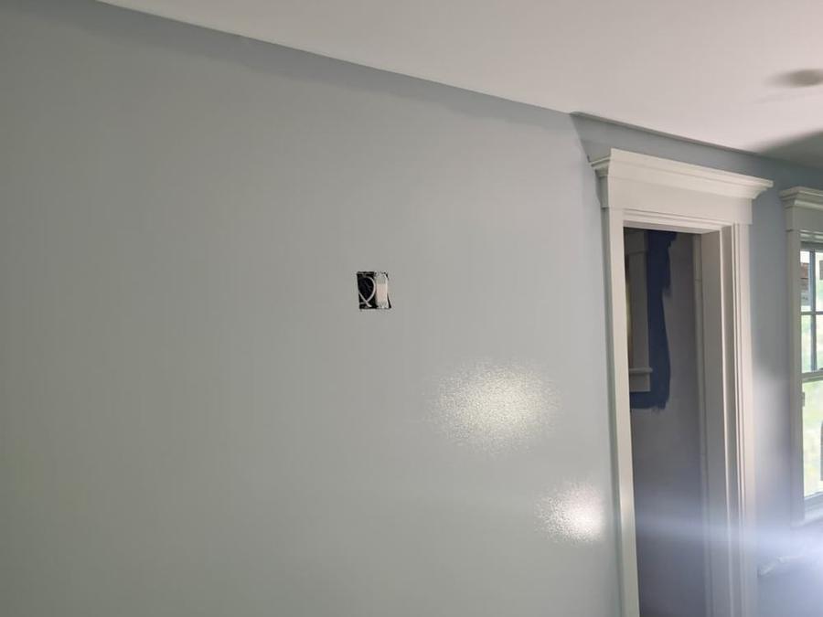 Smooth blue-gray wall next to painted door casing