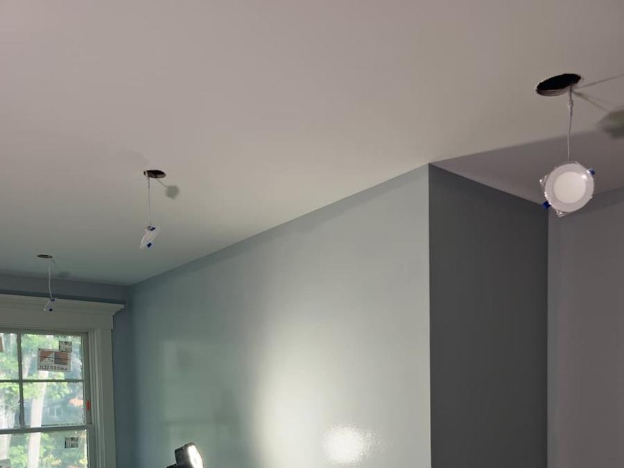 Bedroom with blue-gray walls, white ceiling, and window trim